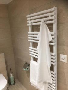 a towel rack in a bathroom with white towels at La Béraille in Thônex