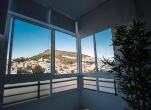 マラガにあるWONDERFUL CENTRAL APARTMENT PANORAMICS VIEWS Wifiの市街の景色を望む窓付きの客室です。