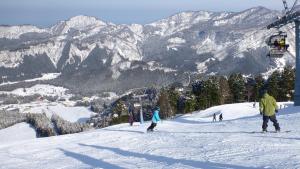 a group of people skiing down a snow covered mountain at Tateyama Kokusai Hotel in Toyama