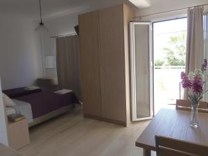 A bed or beds in a room at Angelica Studios and Apartments