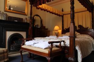 a bedroom with a canopy bed and a fireplace at Bail House in Lincoln