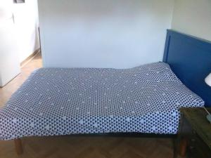 a bed in a room with a blue wall at Chantilly in Orvault