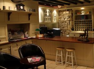a kitchen with a wooden counter top and wooden chairs at Bail House in Lincoln