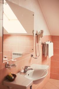 La salle de bains est pourvue d'un lavabo et d'un miroir. dans l'établissement Golden Embankment, à Pskov