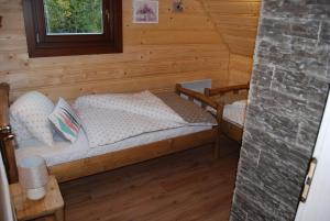 A bed or beds in a room at Chata Nezábudka