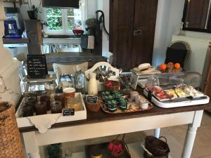 a table with various food items on it at Logis Hôtel DOMAINE du MOULIN in Saint-Avold