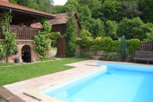 a swimming pool in the yard of a house at Chalupa Dana in Víchová nad Jizerou