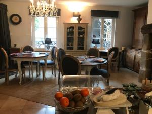 a kitchen and dining room with tables and chairs at Logis Hôtel DOMAINE du MOULIN in Saint-Avold +72 photos