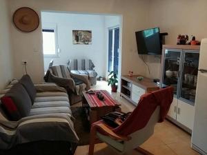 a living room with two couches and a tv at Gogi apartman in Okrug Donji
