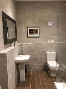 a bathroom with a toilet, sink and mirror at Best Western Walworth Castle Hotel in Darlington