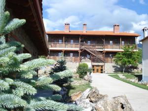 an exterior view of a large house with a tree at Prespa Resort & Spa in Platy