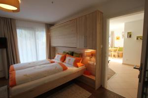 a bedroom with a large bed with a wooden headboard at Appartement Wildkogel in Neukirchen am Großvenediger