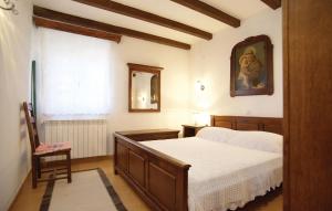 a bedroom with a bed and a mirror and a window at Villa Dabo in Novalja