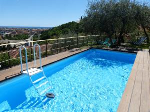 a swimming pool on a balcony with a view at Olive Press Lodge in Chiavari