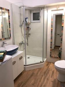 a bathroom with a shower and a sink and a toilet at Boem Apartment in Constanţa