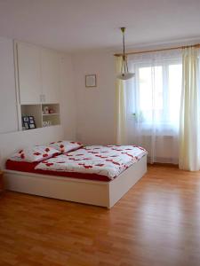 a bedroom with a bed and a large window at Apartment Lilly Olomouc in Olomouc