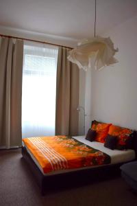 a bedroom with a large bed with a window at Apartment Olomouc Centre in Olomouc