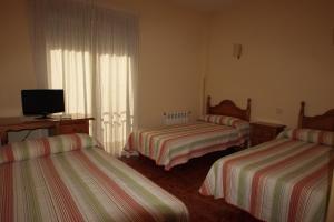 Postel nebo postele na pokoji v ubytování Hostal Sunami