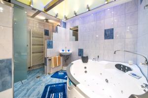 a large bathroom with a tub and a sink at Appart-Pension Seehang in Velden am Wörthersee