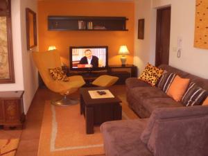 a living room with a couch and a tv at Villa Jelena in Zadar