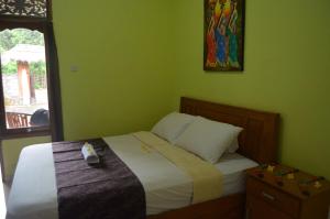 Postel nebo postele na pokoji v ubytování Made Roejas Homestay