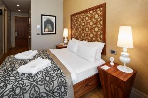 a bedroom with a large bed with two white pillows at Taksim Prelude Hotel in Istanbul +42 photos