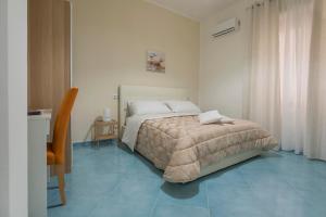a bedroom with a bed and blue tile floors at Ad Maiora in Salerno