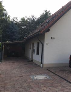 a house with a garage and a brick driveway at Ferienwohnung Held in Erding