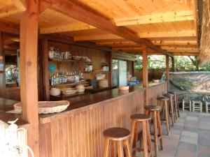 a bar with stools in a wooden building at Hotel Happy Caretta in Dalyan