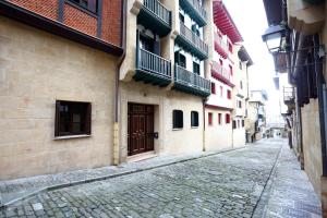 a cobblestone street in an alley with buildings at Tolosa by Smiling Rentals in Hondarribia