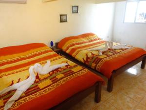 two beds sitting next to each other in a room at House Rapunzel in Oslob