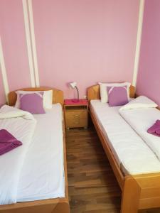 A bed or beds in a room at Guest House Lisinski Raj