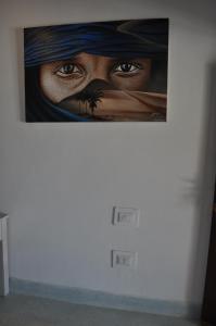 a painting of a woman on a wall at Coral Village in Malindi