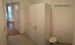 a room with a large white cabinet and a chair at Jcamp in Nové Město pod Smrkem