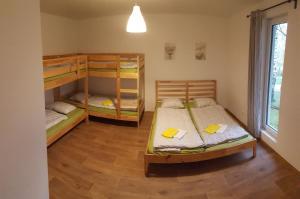 a room with two bunk beds and a window at Jcamp in Nové Město pod Smrkem