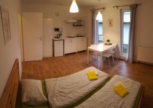 a room with a bed and a table and a kitchen at Jcamp in Nové Město pod Smrkem