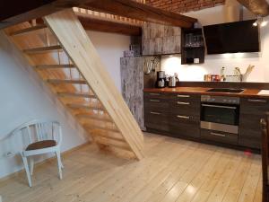 a kitchen with a wooden staircase in a kitchen at Johannes Hof in Bunde