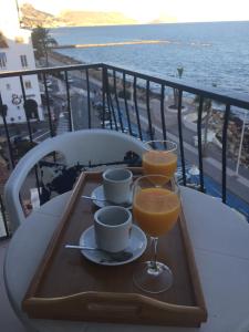 a tray with two glasses of orange juice on a table at Hotel San Miguel in Altea