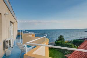 a balcony of a building with a view of the ocean at Apartments Panorama Ravda in Ravda