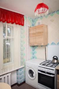 ドニプロにあるApartments on Kyrchatovaのキッチン(コンロ、洗濯機付)