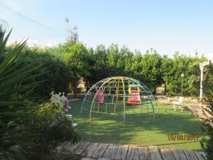 a playground in a garden with a play structure at Pescandora in Bisceglie