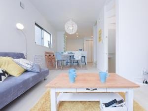 a living room with a couch and a table at THE HOUSE Ikebukuro Sugamo in Tokyo