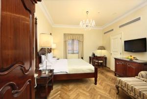 a hotel room with a bed and a television at The Dominican in Prague