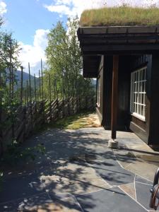 a building with a grass roof with a pathway at Kirkebøen Hytter in Hemsedal