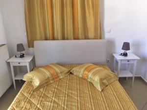 a bedroom with a bed with two night stands at Papanikola House 1 in Astypalaia