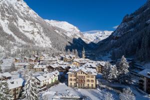 a small town covered in snow in the mountains at Residence Blumental in Gressoney-Saint-Jean