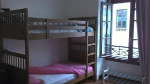 a room with two bunk beds and a window at Casa Azul Hostel in Sintra
