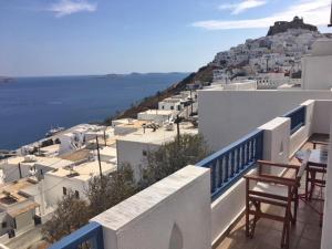 a balcony with chairs and a view of the ocean at Papanikola House 2 in Astypalaia