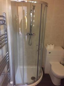 a bathroom with a shower and a toilet at Crescent Hotel in Reading