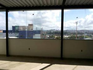 an empty room with a view of a city from a window at Hotel Reobot in Garanhuns +5 photos